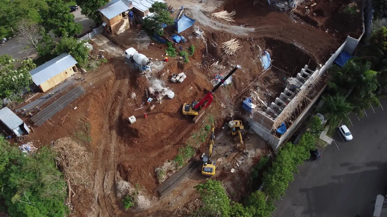 Aerial view of the Dago Pakar Residence site with a row of soldier pile heads retaining the edge of the plot along the road